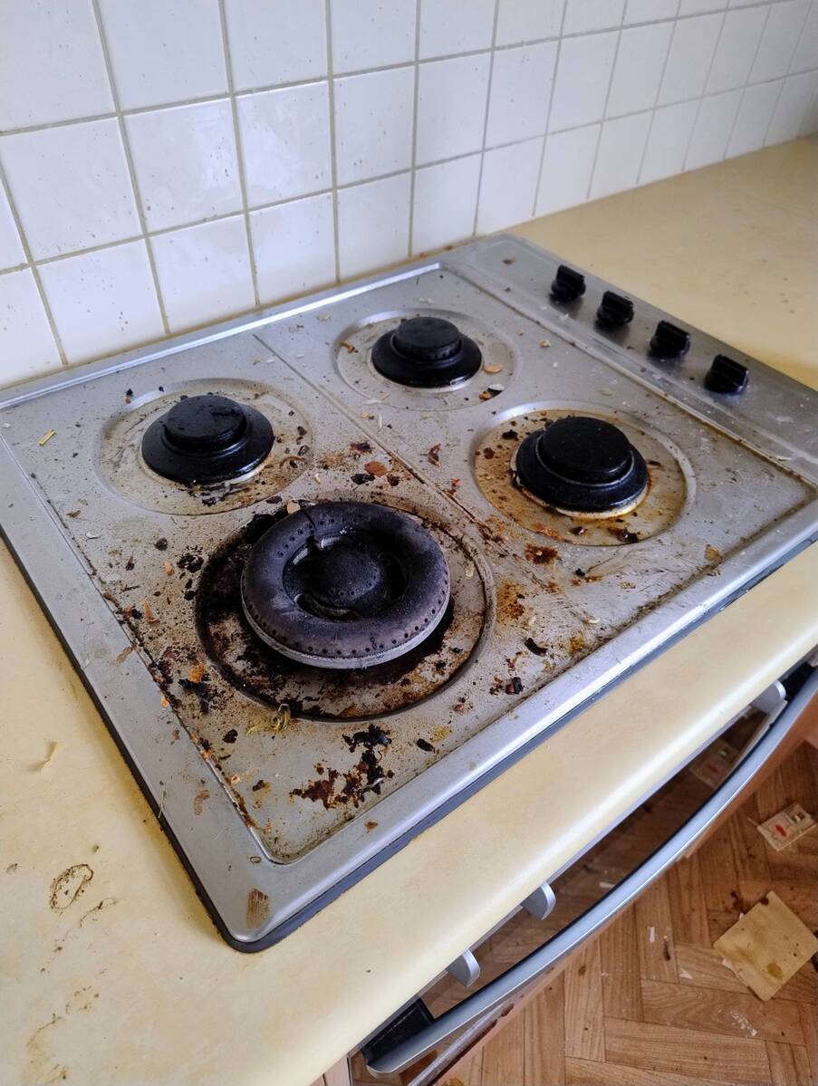 An oven with built up residue before our clean