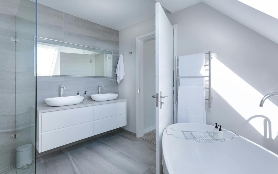A sleek contemporary bathroom with a freestanding bathtub and twin sinks.